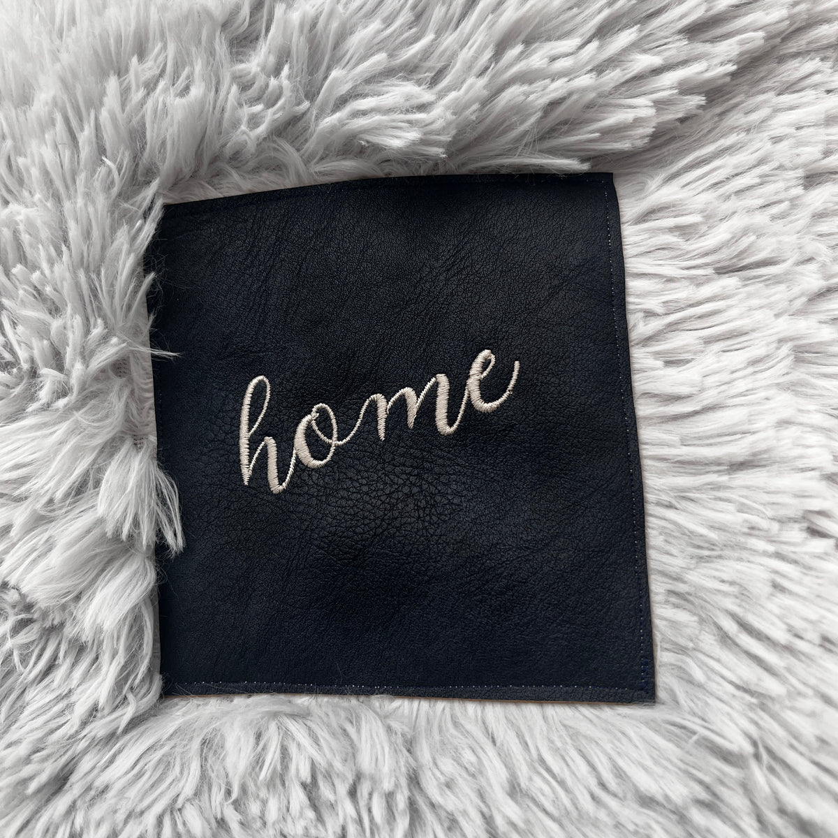 “HOME” Embroidered Patch Blanket – Non-Shedding Faux Fur Throw with Vegan Leather Patch